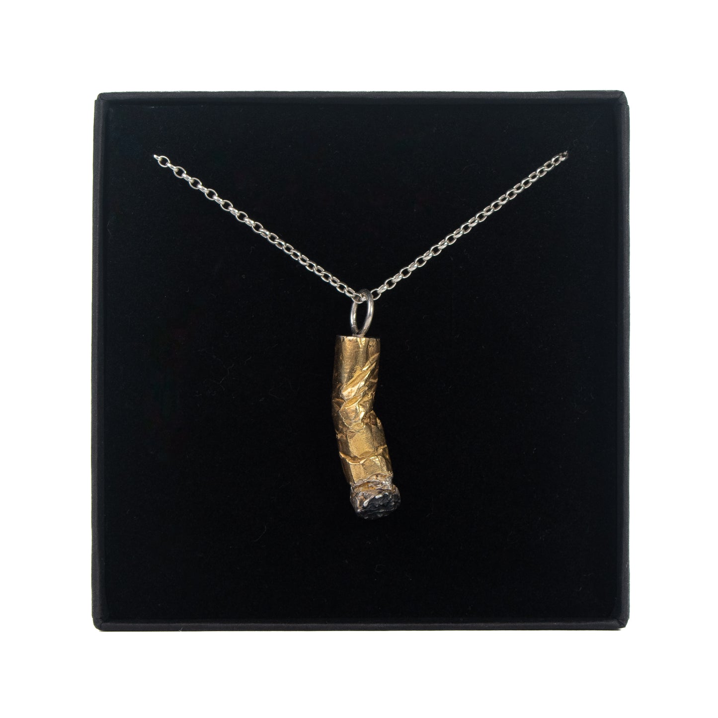 Cast Dout Sterling silver cigarette end pendant with 24k gold plating displayed in gift box