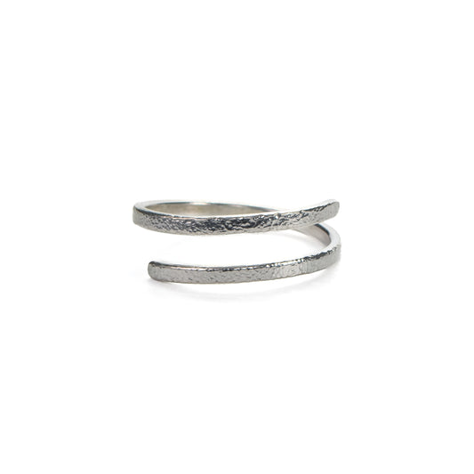 Adjustable hammered silver ring with fine textured finish on white background