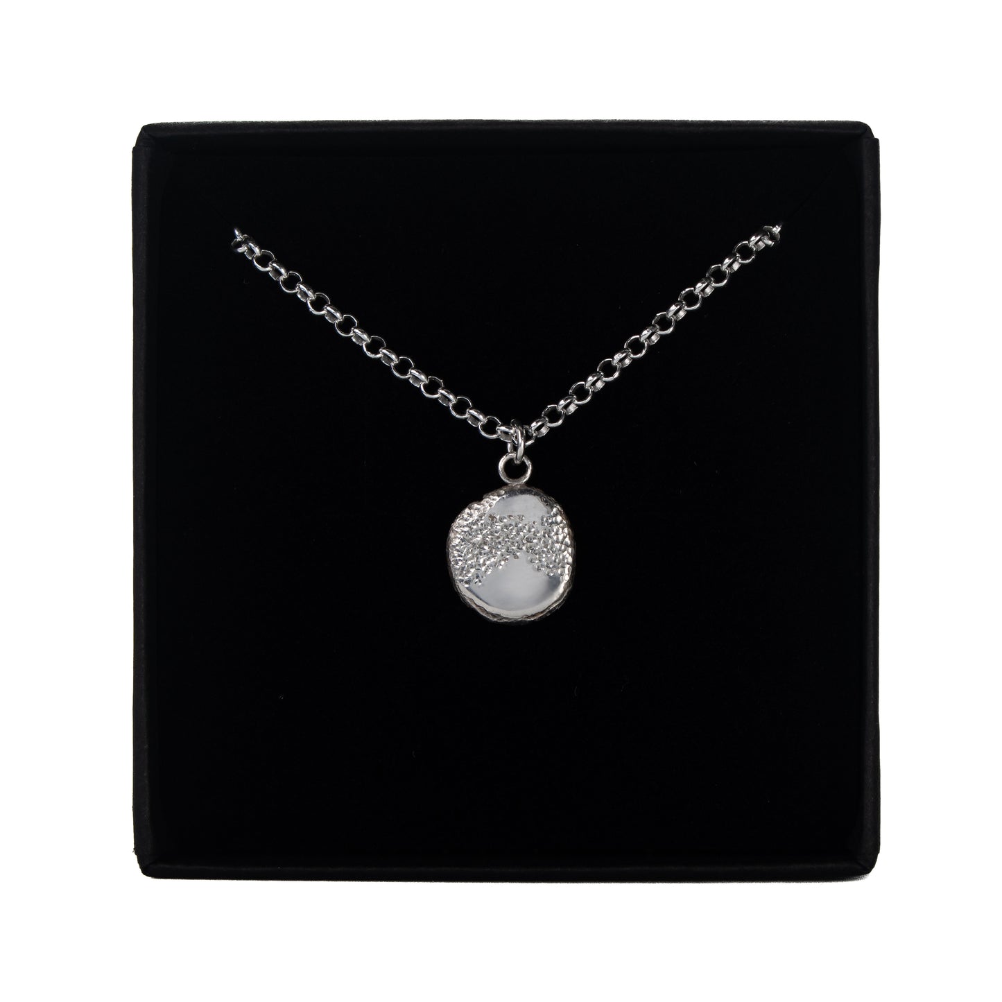 The Aether Pendant recycled organic silver necklace in its presentation box.