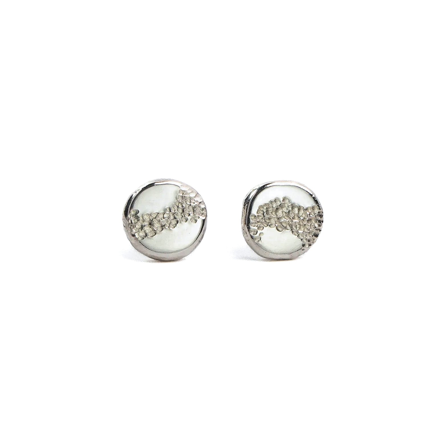 Aether stud earrings in recycled organic sterling silver with soft hammered texture and irregular circular form.