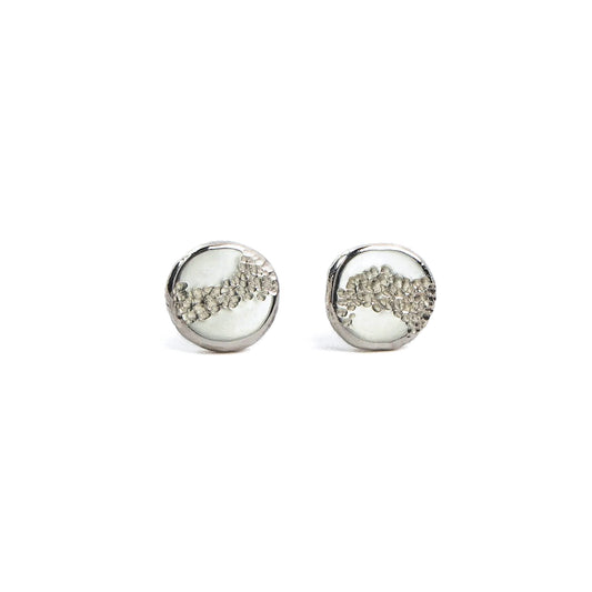 Aether stud earrings in recycled organic sterling silver with soft hammered texture and irregular circular form.