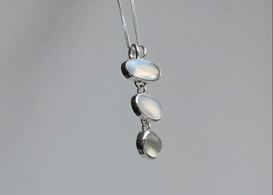 Custom moonstone pendant on grey background