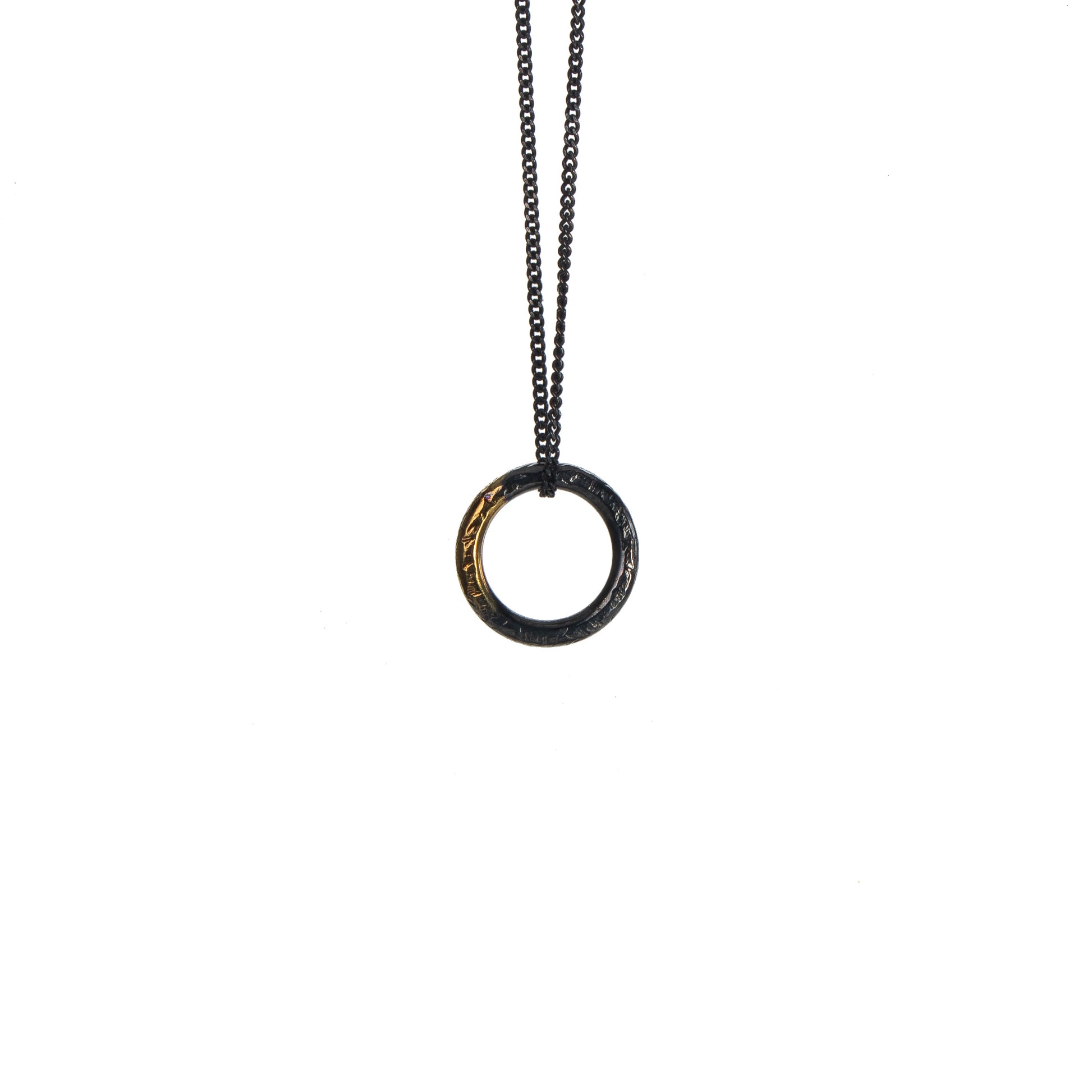 Oxidised silver circle necklace with gold detail on white background