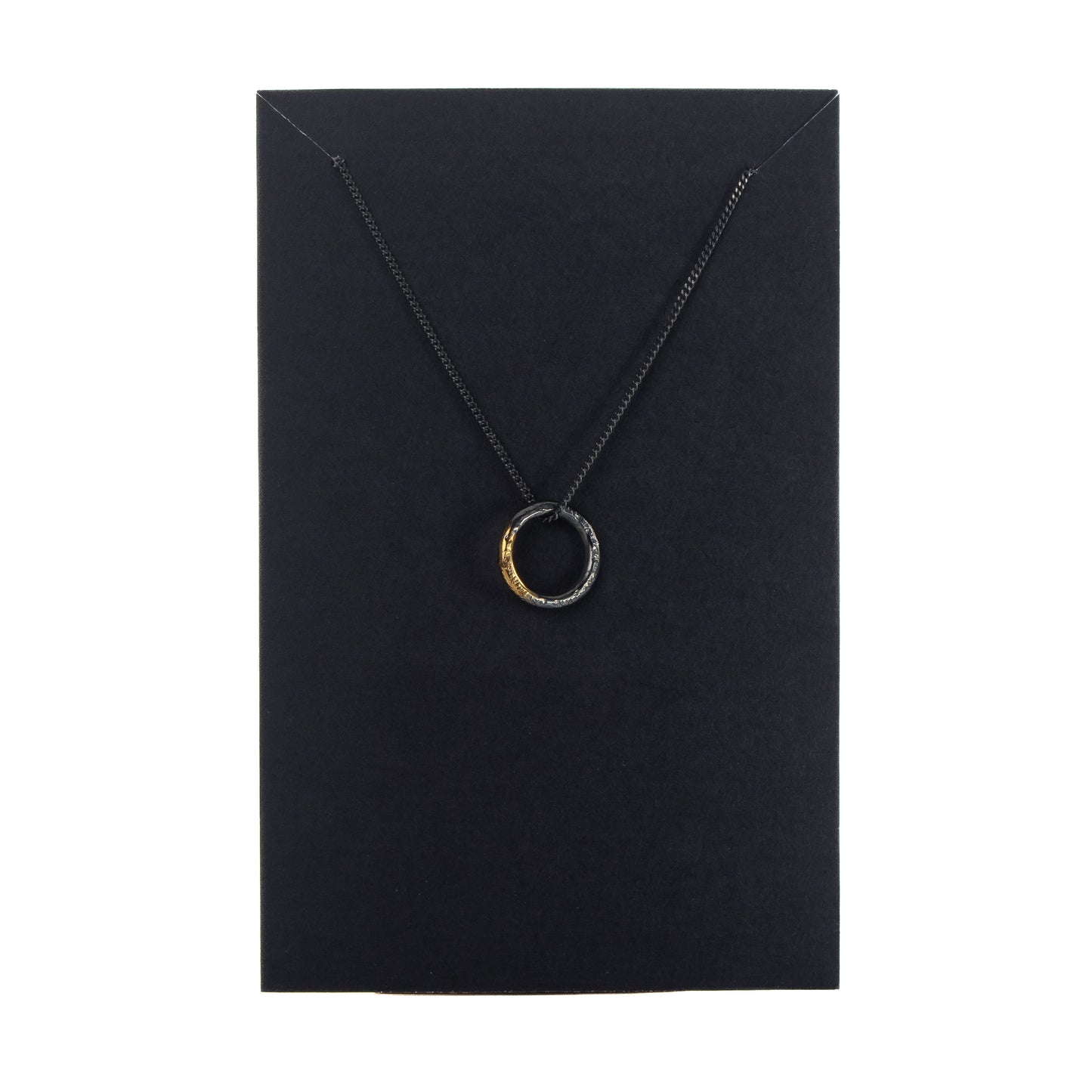 Oxidised silver circle necklace with gold detail displayed on black jewellery card