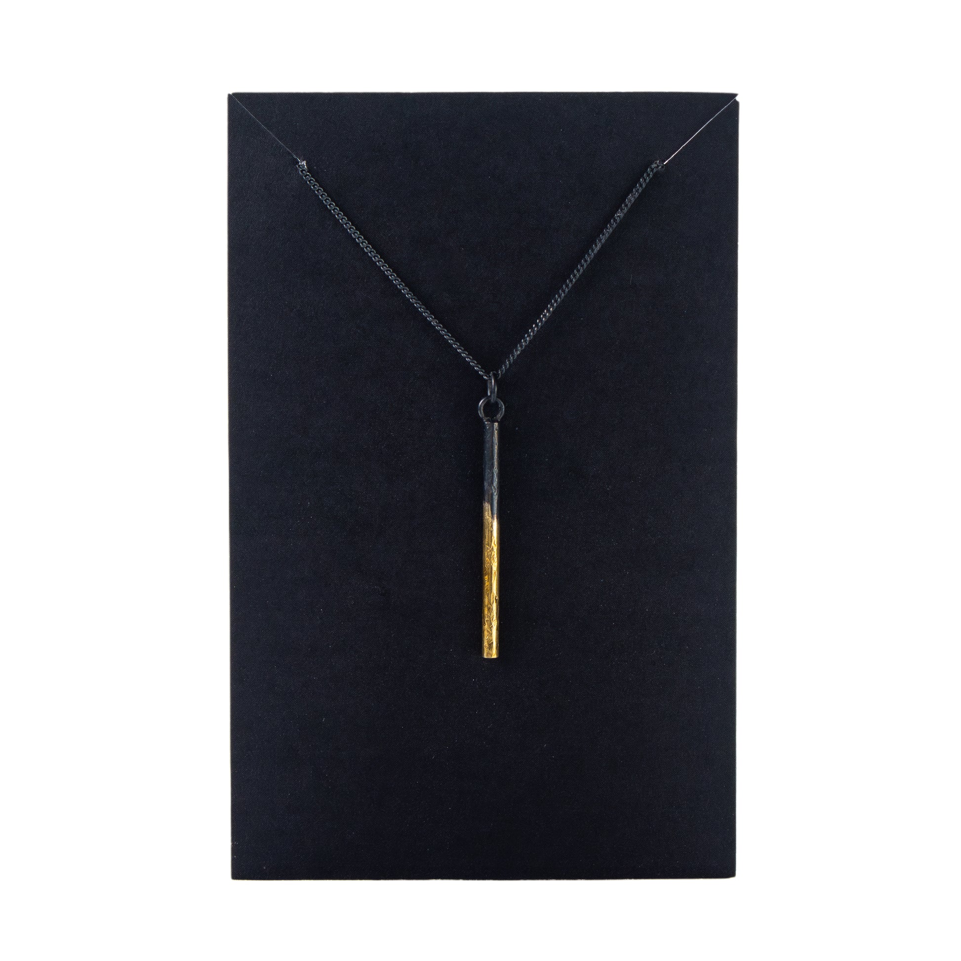 Oxidised silver pillar pendant necklace with gold detail on black display card