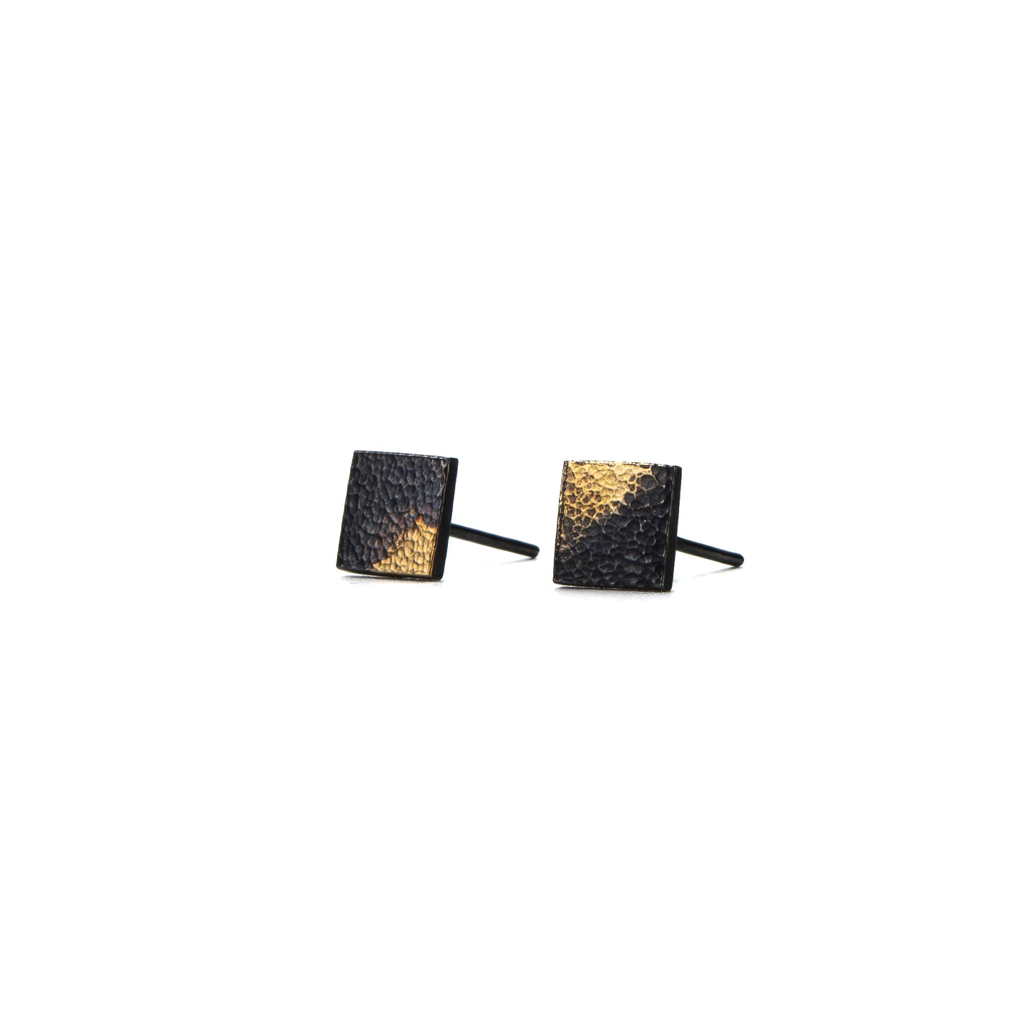 Side angle of oxidised silver square stud earrings showing texture and gold detail.