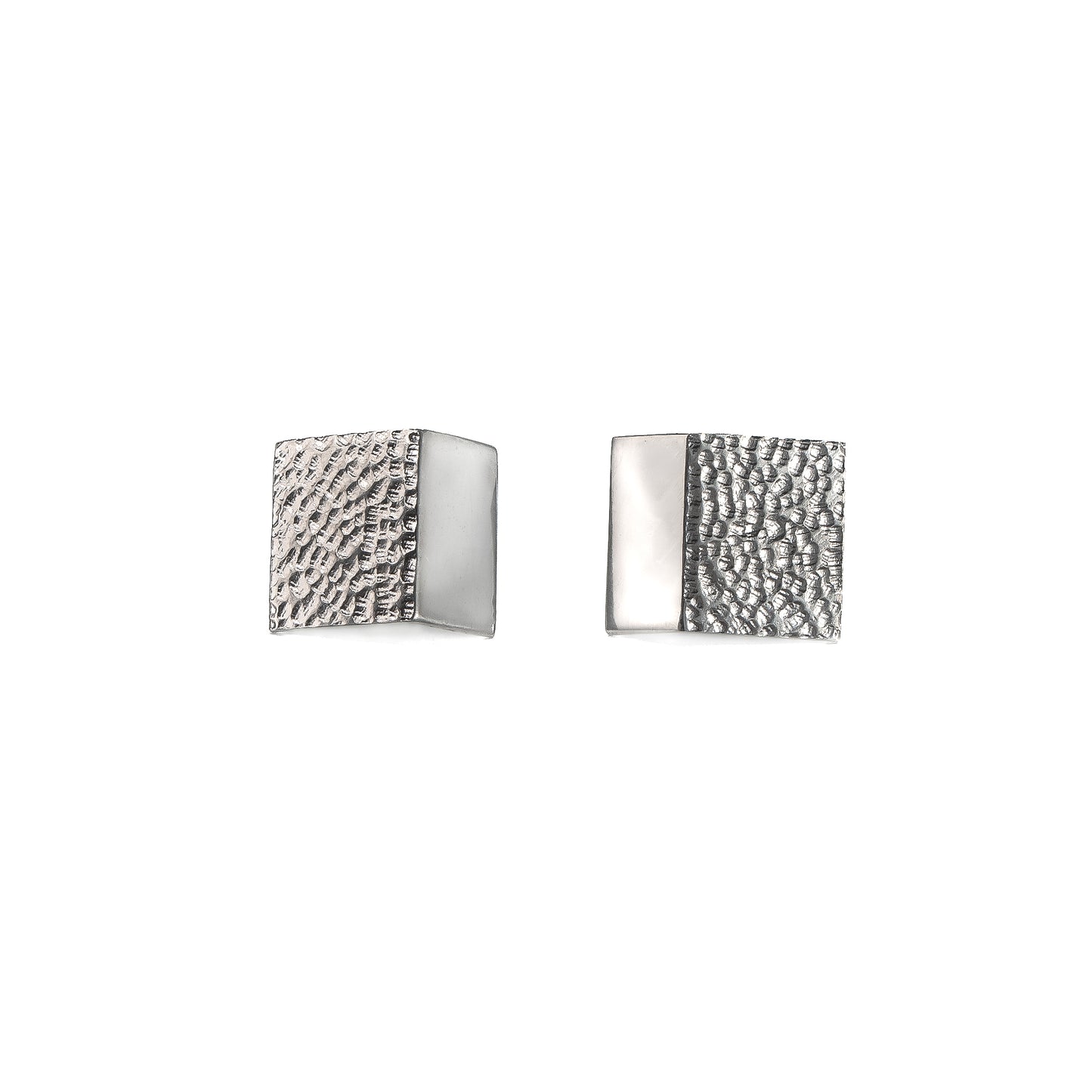 Rectangular silver stud earrings with a hand carved texture on a white background