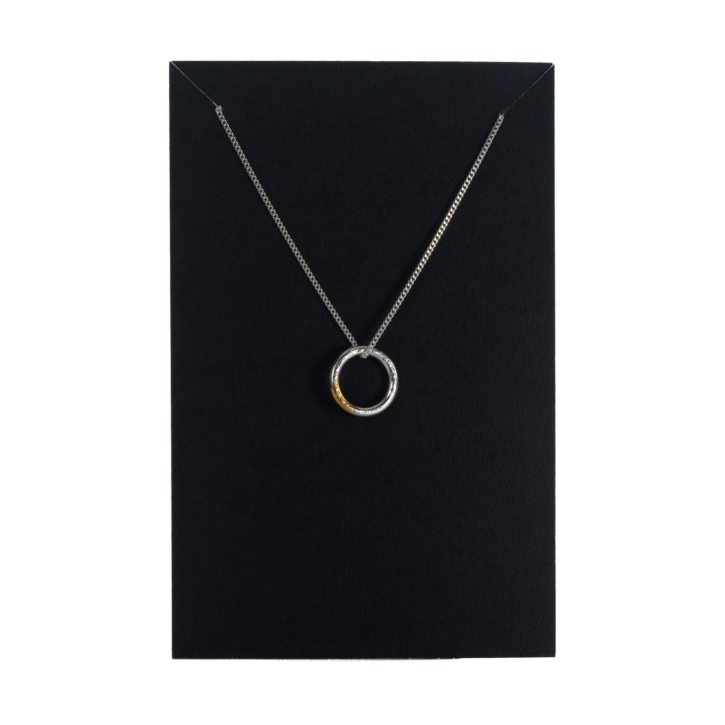 Sterling silver circle necklace with gold detail displayed on black jewellery card
