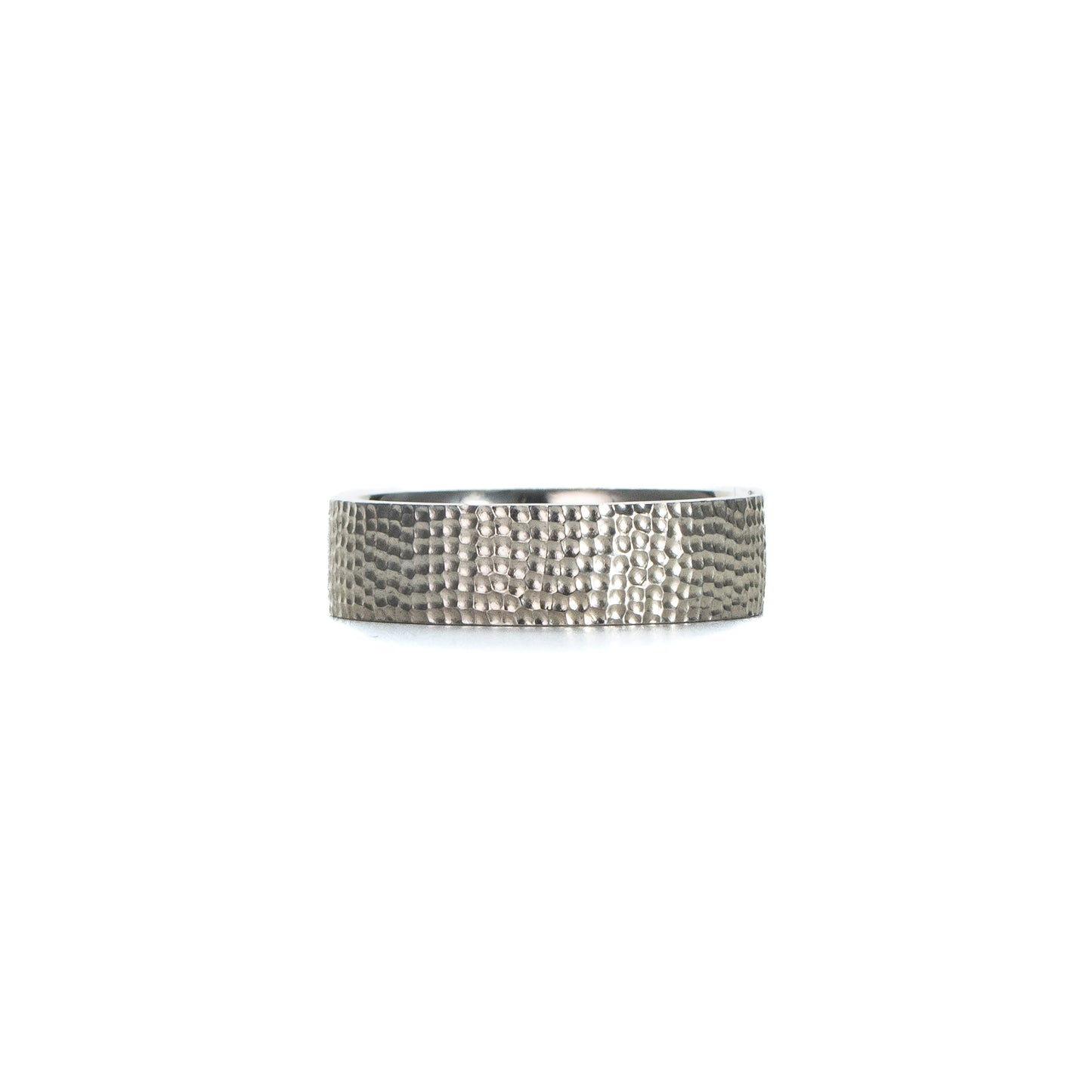 Textured silver band ring in sterling silver with a hand-carved surface on white background