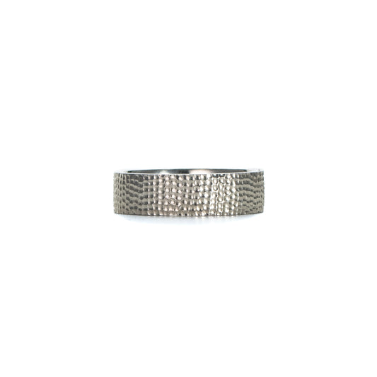 Textured silver band ring in sterling silver with a hand-carved surface on white background