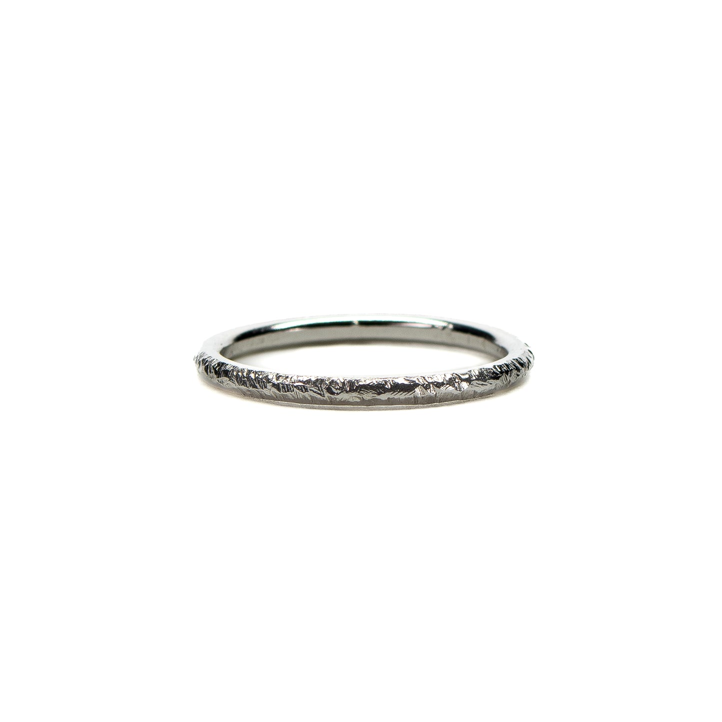 Rough hammered textured silver stacking ring on white background