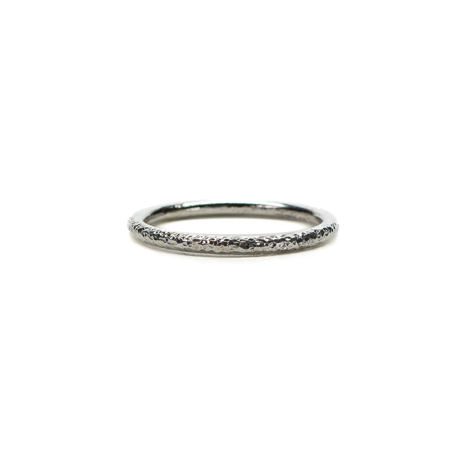Tiny hammered textured silver stacking ring on white background